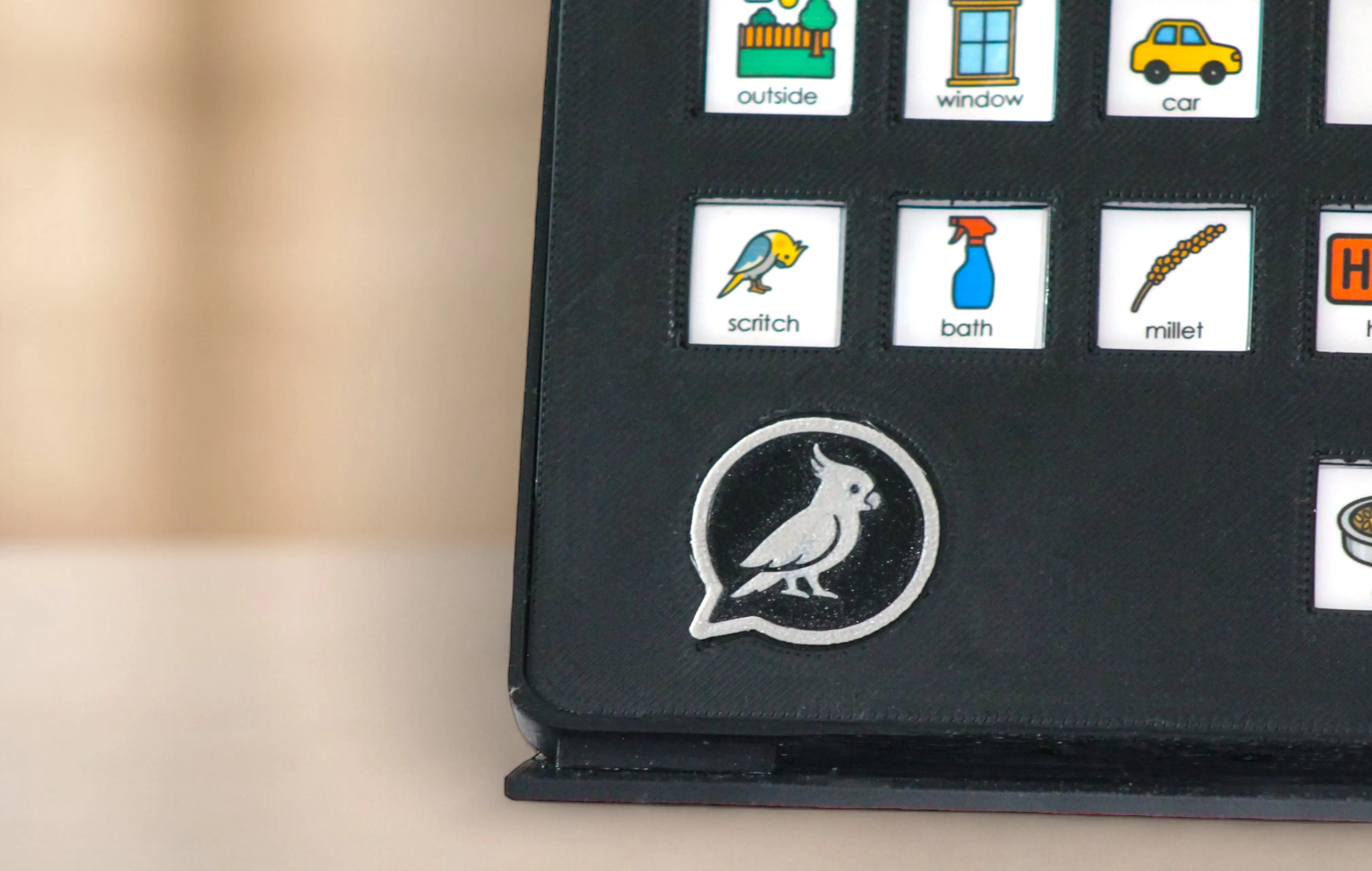 FeatherTalks tablet-style AAC communication board for birds